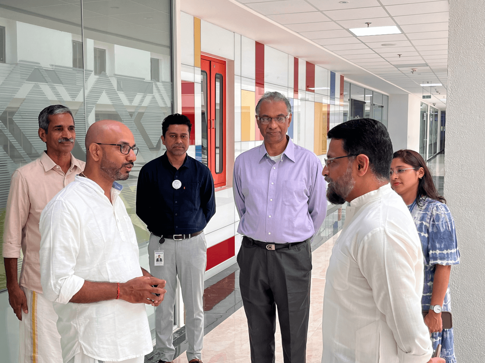 Col Nair in conversation with Mr. Premjith, as Park Centre officials, including Mr. Vasanth Varada, DGM Marketing and Customer Relationship, Technopark, look on.