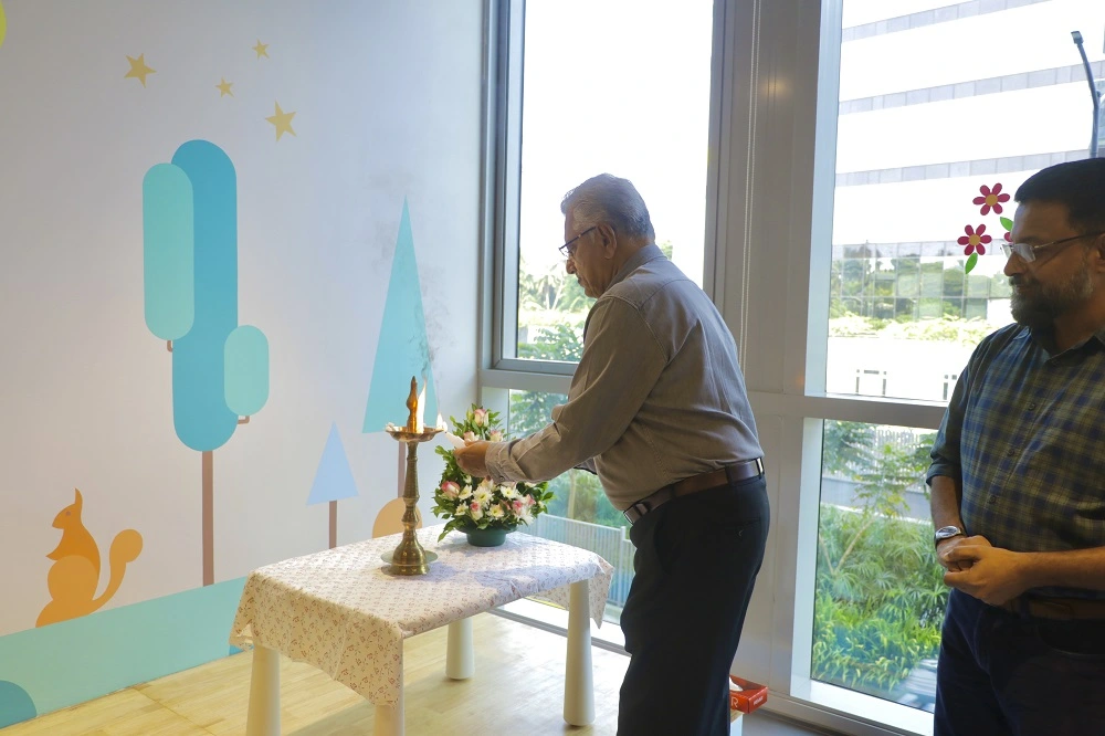 Mr. P Jacob, Chairman, Global Public School, lighting the ceremonial lamp at the launch of Stepping Stones creche and kindergarten by Global Public School at Technopark Phase III.